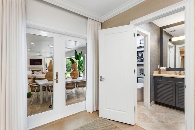 bathroom featuring crown molding, french doors, and vanity