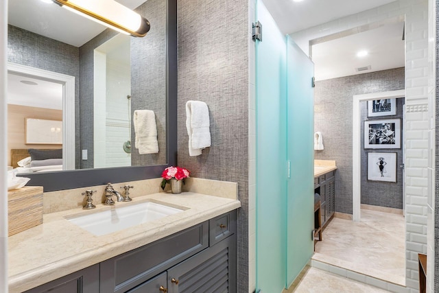 bathroom featuring tile patterned flooring and vanity