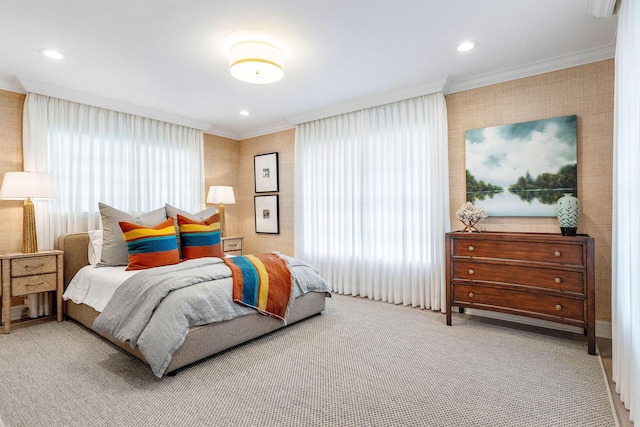 bedroom with light colored carpet and crown molding