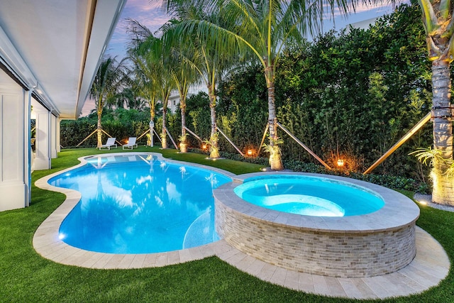 pool at dusk with a lawn