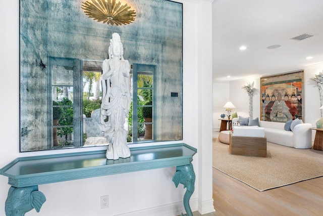 bathroom featuring hardwood / wood-style floors and crown molding