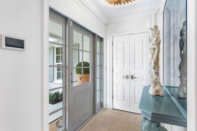 entryway featuring ornamental molding