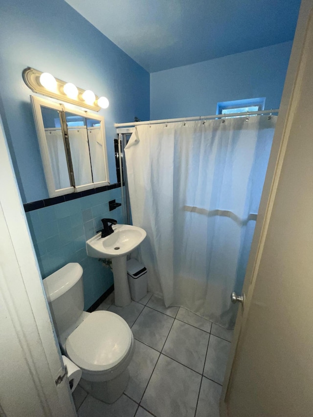 bathroom with tile patterned floors, tile walls, toilet, and a shower with shower curtain