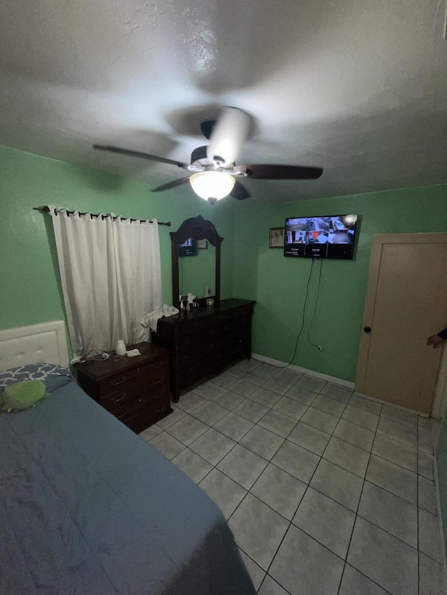 bedroom with ceiling fan and light tile patterned flooring