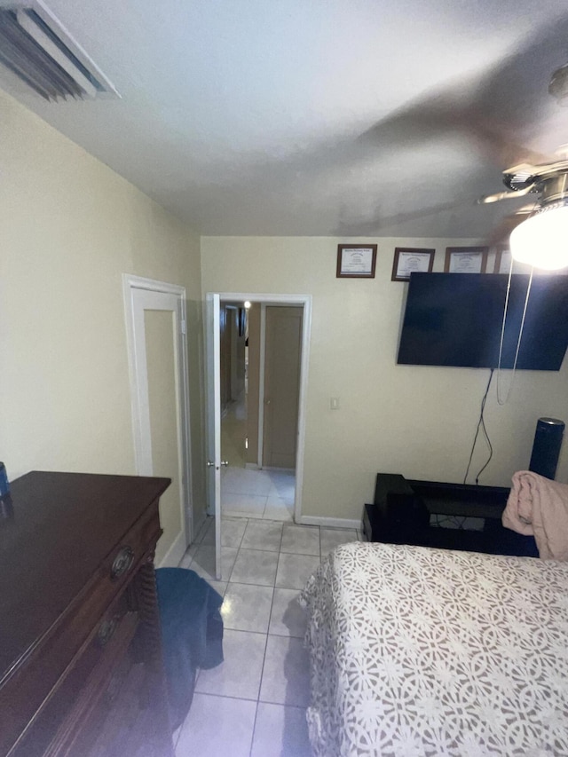 bedroom with ceiling fan and light tile patterned floors