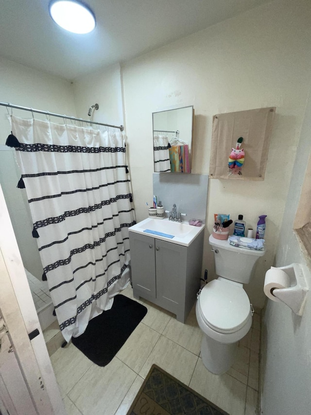 bathroom featuring vanity, toilet, tile patterned flooring, and a shower with curtain