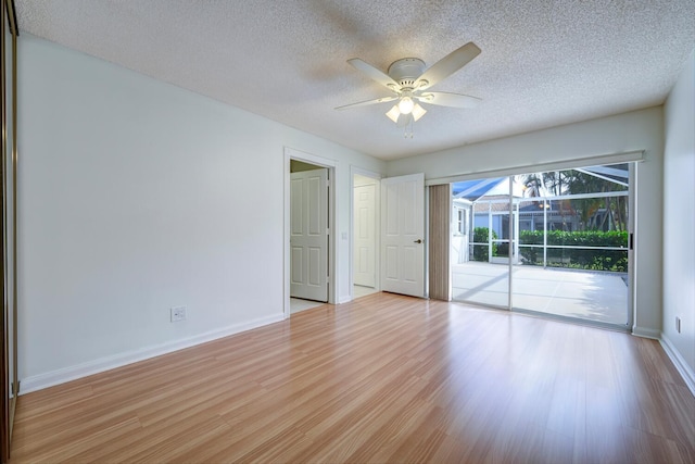 spare room featuring ceiling fan, a textured ceiling, and light wood-type flooring