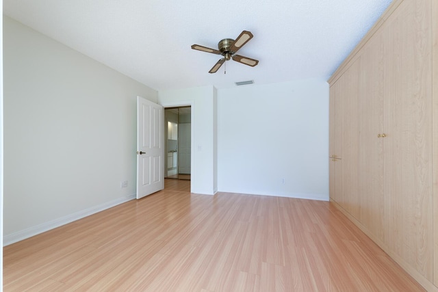 unfurnished room with ceiling fan and light hardwood / wood-style flooring