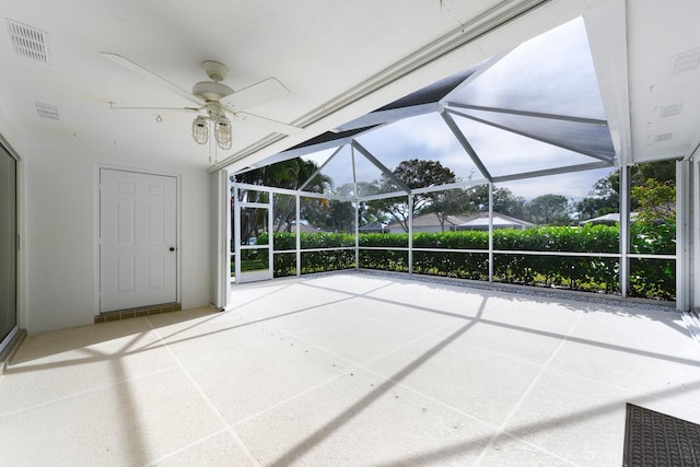 view of patio featuring glass enclosure and ceiling fan