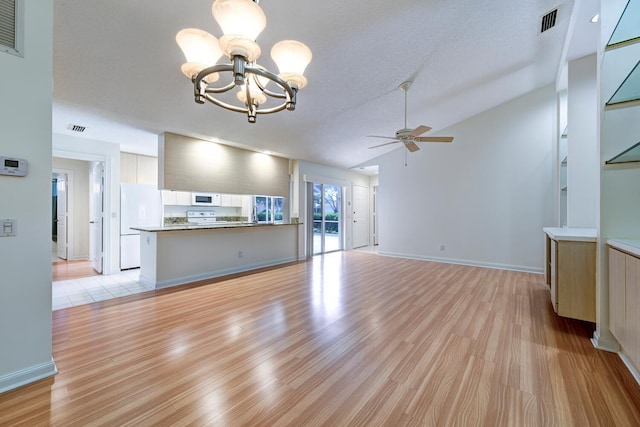 unfurnished living room featuring a textured ceiling, ceiling fan with notable chandelier, light hardwood / wood-style floors, and lofted ceiling