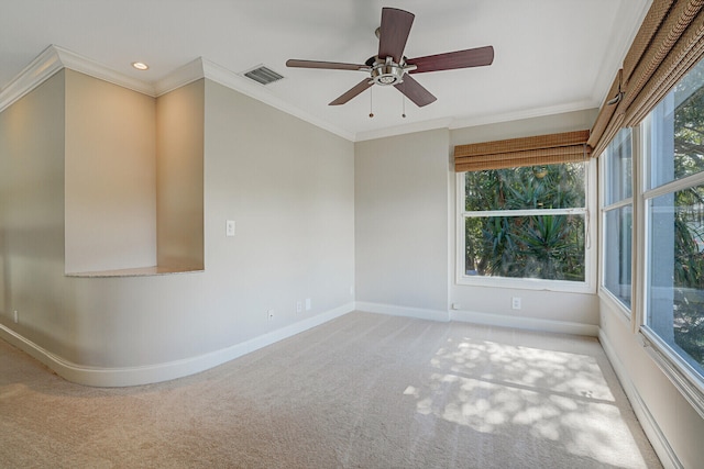 carpeted spare room featuring ceiling fan and ornamental molding