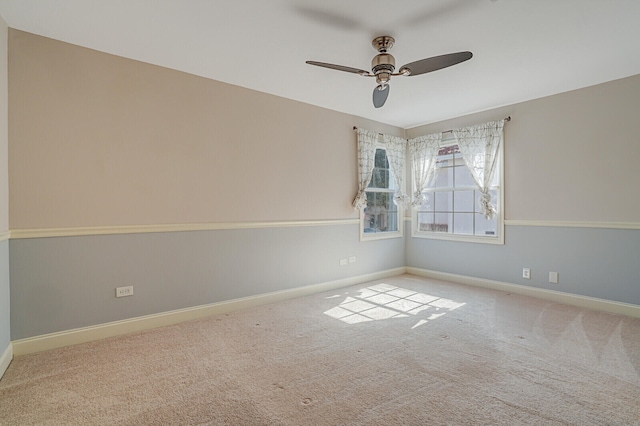 spare room with light carpet and ceiling fan