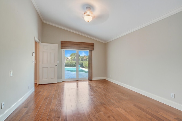 empty room featuring light wood-type flooring, crown molding, lofted ceiling, and ceiling fan