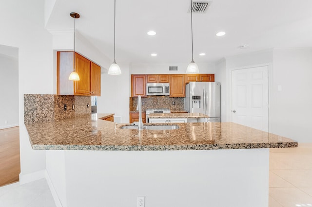 kitchen with pendant lighting, appliances with stainless steel finishes, backsplash, kitchen peninsula, and light tile patterned floors