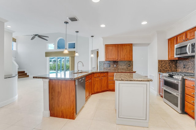 kitchen with ceiling fan, appliances with stainless steel finishes, decorative backsplash, decorative light fixtures, and sink