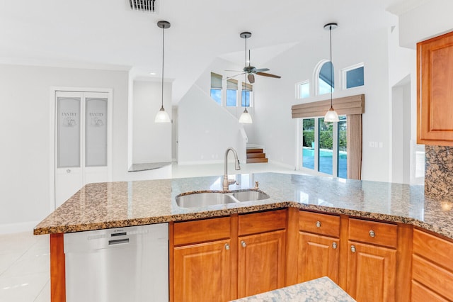 kitchen with ceiling fan, light stone countertops, dishwasher, and sink