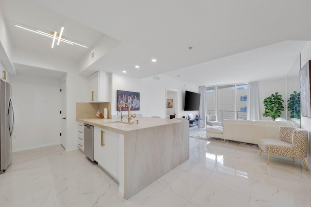 kitchen with kitchen peninsula, sink, and stainless steel appliances