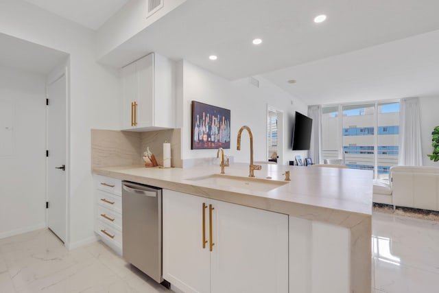 kitchen with backsplash, dishwasher, white cabinets, and sink