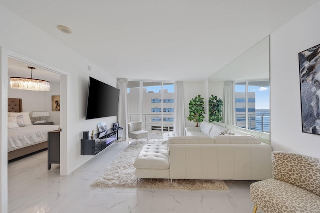 living room with floor to ceiling windows and a notable chandelier