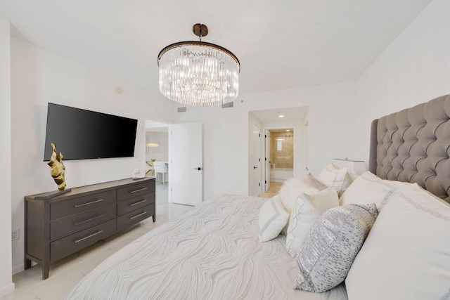 bedroom with connected bathroom and an inviting chandelier