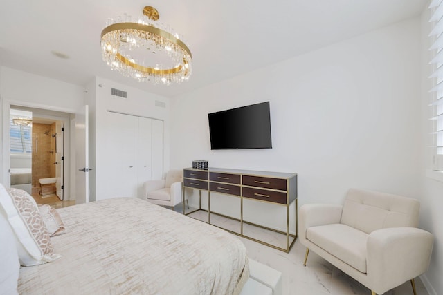 bedroom with a notable chandelier and ensuite bath