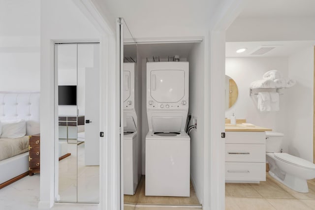 laundry area with stacked washing maching and dryer