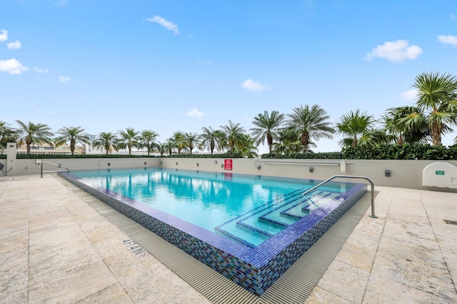 view of swimming pool with a patio