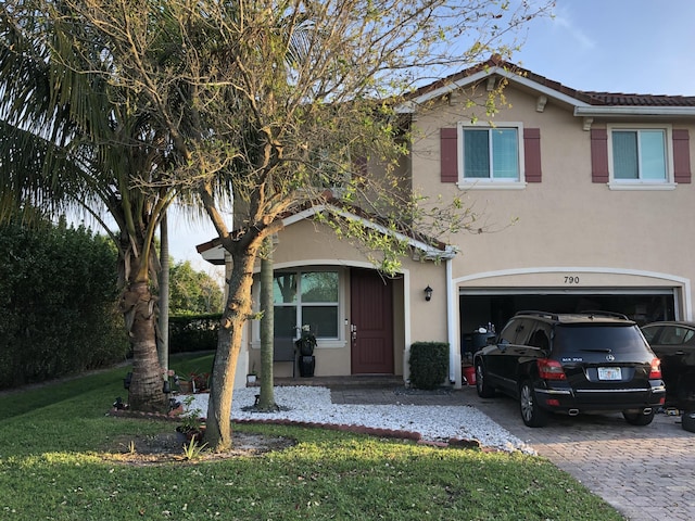 view of front of property featuring a front yard and a garage