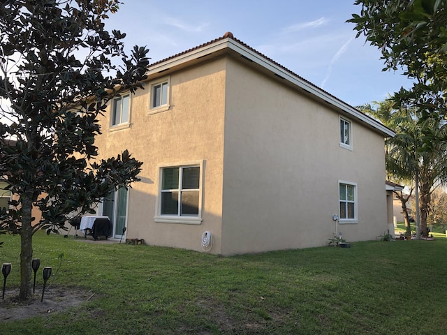 view of property exterior with a yard