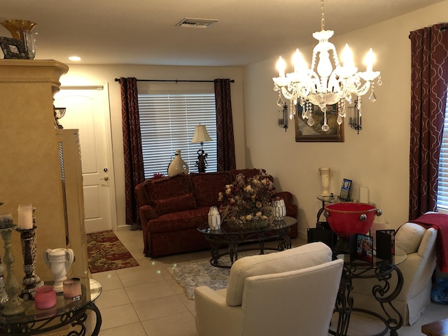 living room featuring a chandelier and light tile patterned floors