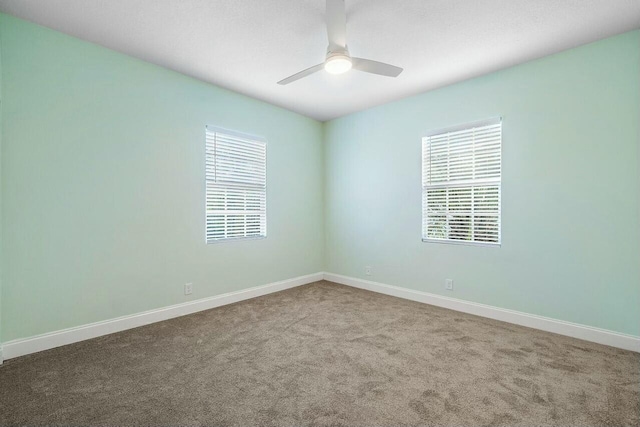 empty room with ceiling fan and carpet floors