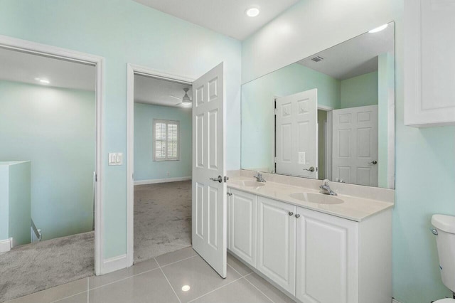 bathroom featuring tile patterned flooring, vanity, and toilet