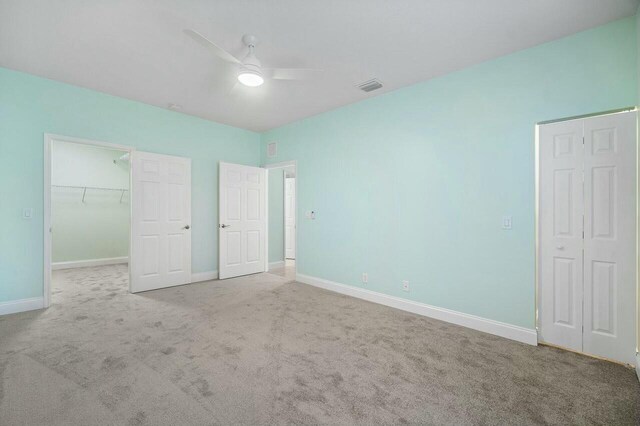 carpeted spare room with ceiling fan