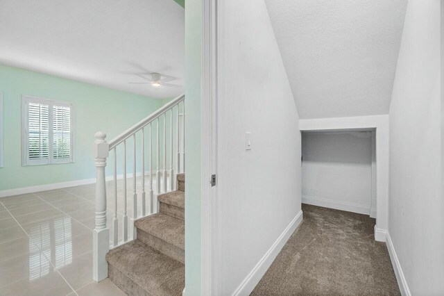 unfurnished bedroom featuring ceiling fan and carpet floors