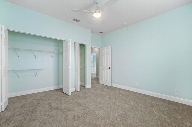 unfurnished bedroom with ceiling fan, a closet, and carpet floors