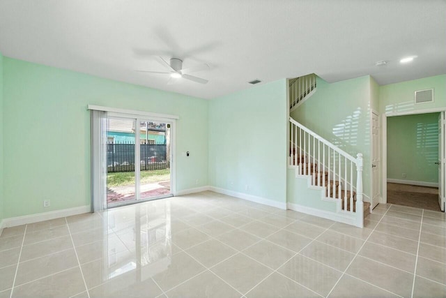 tiled empty room featuring ceiling fan