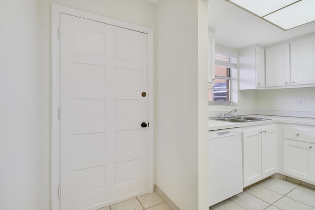 kitchen with light tile patterned floors, sink, white cabinets, and dishwasher