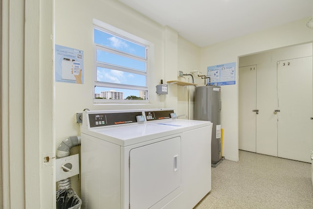 laundry room featuring water heater and washing machine and dryer