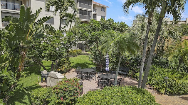 view of home's community featuring a yard and a patio