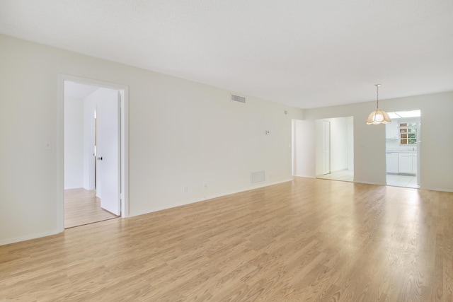 unfurnished room featuring light wood-type flooring