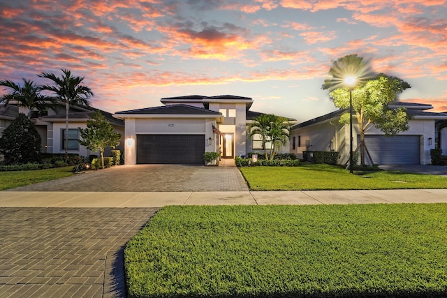 prairie-style home with a lawn and a garage