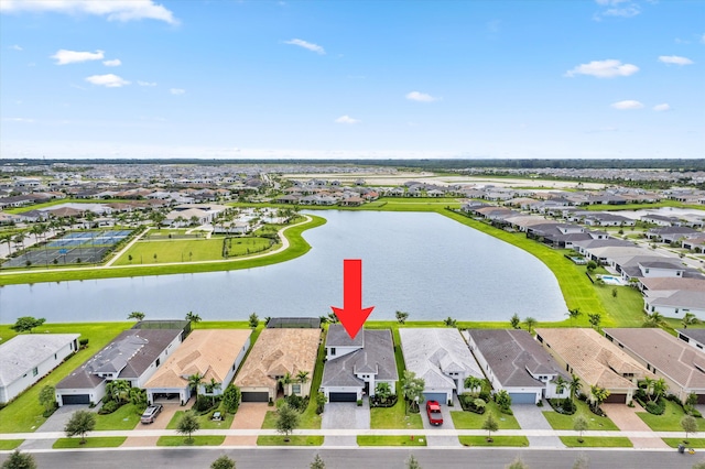 birds eye view of property with a water view