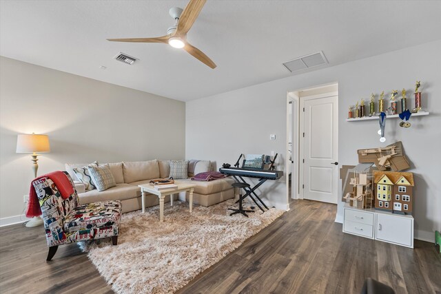 living room with dark hardwood / wood-style floors and ceiling fan