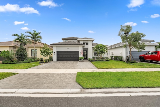 view of front of property with a front lawn and a garage