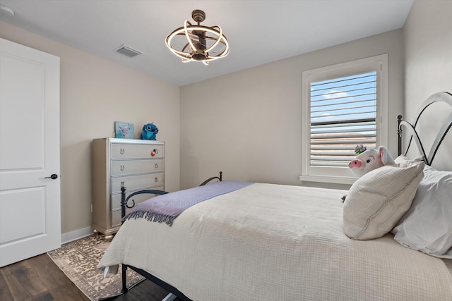 bedroom with dark hardwood / wood-style flooring