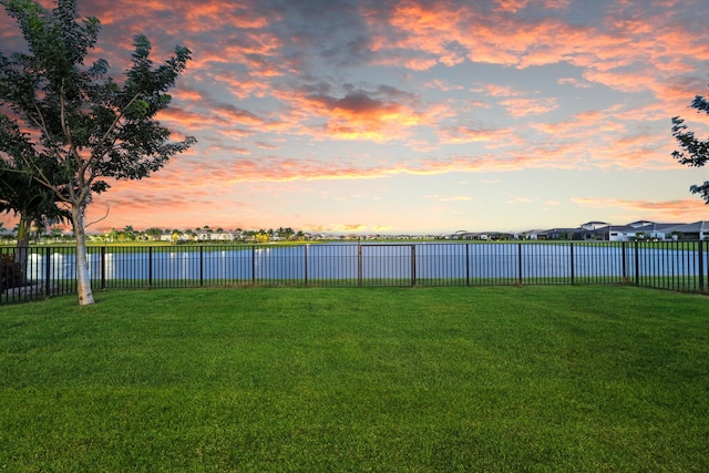 yard at dusk with a water view