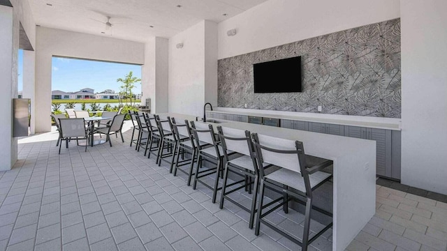 view of patio featuring an outdoor bar