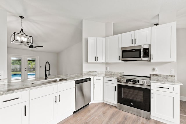 kitchen with french doors, sink, ceiling fan, appliances with stainless steel finishes, and white cabinetry