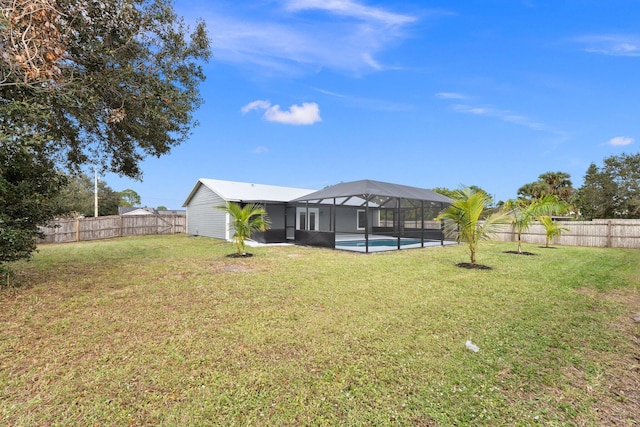 view of yard with a fenced in pool and glass enclosure