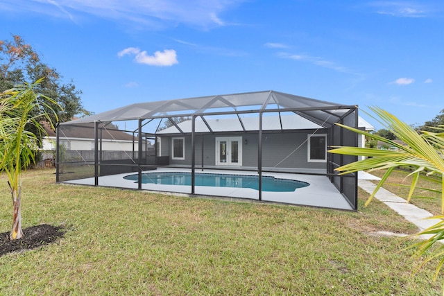 back of property with a lawn, glass enclosure, and a fenced in pool